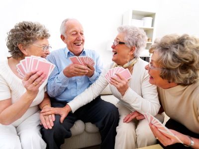 Active Retirement Community Residents Playing Cards